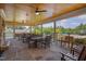 Spacious covered patio with stone flooring, wood ceiling, ceiling fans, and plenty of seating at 149 N Serenity Hill Cir, Chapel Hill, NC 27516