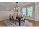 Elegant dining room featuring stylish lighting, wainscoting, and a large window at 149 N Serenity Hill Cir, Chapel Hill, NC 27516