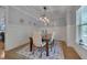 Elegant dining room with coffered ceilings, wainscoting, and stylish light fixture at 149 N Serenity Hill Cir, Chapel Hill, NC 27516