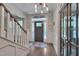 Bright foyer with hardwood floors, staircase with white banister, and decorative wall trim at 149 N Serenity Hill Cir, Chapel Hill, NC 27516