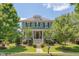Charming two-story home with inviting front porch, manicured landscaping and stairway leading to the front door at 149 N Serenity Hill Cir, Chapel Hill, NC 27516