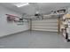 Spacious garage with epoxy flooring, overhead storage racks, and ample space for vehicles and equipment at 149 N Serenity Hill Cir, Chapel Hill, NC 27516