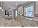 Bright kitchen featuring granite countertops, stainless steel sink, and white cabinets with modern finishes at 149 N Serenity Hill Cir, Chapel Hill, NC 27516