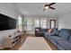 Bright living room featuring a comfy blue sectional sofa, fireplace, and large windows at 149 N Serenity Hill Cir, Chapel Hill, NC 27516