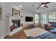 Cozy living room with a fireplace, plush seating, and natural light at 149 N Serenity Hill Cir, Chapel Hill, NC 27516