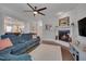 Open-concept living room with a fireplace, comfortable sofa, and seamless flow to the kitchen at 149 N Serenity Hill Cir, Chapel Hill, NC 27516
