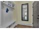 Organized mudroom with built-in bench, coat hooks, shelving, and a stylish wood-look floor at 149 N Serenity Hill Cir, Chapel Hill, NC 27516