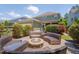 Relaxing backyard patio area with outdoor seating surrounding a stone fire pit for outdoor enjoyment at 149 N Serenity Hill Cir, Chapel Hill, NC 27516