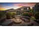 Relaxing backyard patio area at dusk with outdoor seating surrounding a stone fire pit for outdoor enjoyment at 149 N Serenity Hill Cir, Chapel Hill, NC 27516