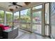 Inviting screened porch with wicker furniture, ceiling fan, and views of the lush backyard at 149 N Serenity Hill Cir, Chapel Hill, NC 27516