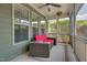 Relaxing screened porch with comfortable seating, a ceiling fan, and a view of the serene outdoor landscape at 149 N Serenity Hill Cir, Chapel Hill, NC 27516