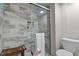 Modern bathroom featuring tiled shower with glass door, bench, and a stylish toilet at 1500 River Mill Dr # 101, Wake Forest, NC 27587