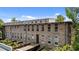 Exterior view of a stone building with multiple stories and scenic surroundings at 1500 River Mill Dr # 101, Wake Forest, NC 27587