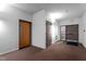 Hallway with multiple doors, neutral carpet, and access to exterior doors at 1500 River Mill Dr # 101, Wake Forest, NC 27587
