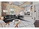 Open-concept living area with modern kitchen, stone walls, and comfortable seating at 1500 River Mill Dr # 101, Wake Forest, NC 27587