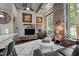 Inviting living room with stone accent wall, modern furnishings, and large windows offering natural light at 1500 River Mill Dr # 101, Wake Forest, NC 27587