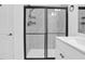 Modern bathroom with glass enclosed shower, white vanity and quartz countertop at 1505 Willow Landing Way, Willow Springs, NC 27592