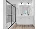 Modern bathroom with double sink vanity, quartz countertops, and glass enclosed shower at 1505 Willow Landing Way, Willow Springs, NC 27592