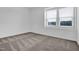 Cozy bedroom featuring a window overlooking the neighborhood, and neutral carpet at 1505 Willow Landing Way, Willow Springs, NC 27592