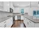 Well-equipped kitchen with granite countertops, stainless steel appliances, and a stylish backsplash at 1505 Willow Landing Way, Willow Springs, NC 27592