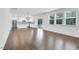 Open-concept living space with hardwood floors seamlessly connects the living room, dining area, and kitchen at 1505 Willow Landing Way, Willow Springs, NC 27592