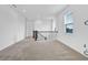 Loft space with plush carpet, modern railing, and plenty of natural light from the window at 1505 Willow Landing Way, Willow Springs, NC 27592