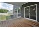 Relaxing screened porch with wood flooring and sliding glass door to inside at 1505 Willow Landing Way, Willow Springs, NC 27592