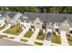 An aerial view of neat townhomes with manicured lawns and driveways on a sunny day at 156 Velvet Ridge Way, Garner, NC 27529