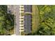 Aerial view of townhomes with dark roofs, parking area, and green spaces, showcasing community living at 156 Velvet Ridge Way, Garner, NC 27529