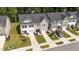 An aerial view of neat townhomes with manicured lawns and driveways on a sunny day at 156 Velvet Ridge Way, Garner, NC 27529