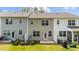 Townhome backyard features patios, green space, and privacy fences, perfect for outdoor entertaining and relaxation at 156 Velvet Ridge Way, Garner, NC 27529