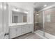 Bright bathroom featuring double sink vanity, ceramic tile flooring and glass enclosed shower at 156 Velvet Ridge Way, Garner, NC 27529