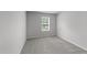 A neutral bedroom features a window, plush carpet, and serene atmosphere at 156 Velvet Ridge Way, Garner, NC 27529