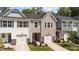 Charming townhomes with single-car garages, manicured lawns, and stone accents create an inviting curb appeal at 156 Velvet Ridge Way, Garner, NC 27529