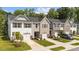 Charming townhomes with single-car garages, manicured lawns, and stone accents create an inviting curb appeal at 156 Velvet Ridge Way, Garner, NC 27529