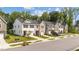 A view of a street with neat townhouses, each featuring a single-car garage and well-kept front lawns at 156 Velvet Ridge Way, Garner, NC 27529
