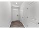 Bright foyer featuring wood-look floors, white walls, and paneled doors for a welcoming entrance at 156 Velvet Ridge Way, Garner, NC 27529