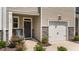 Inviting front entrance with stone accents, a cozy blue chair, and a well-maintained yard at 156 Velvet Ridge Way, Garner, NC 27529