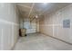 Unfinished two-car garage with concrete floor, drywall, and garage door opener with room for a trash receptacle at 156 Velvet Ridge Way, Garner, NC 27529
