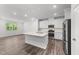 Modern kitchen with white cabinets, stainless steel appliances, and a large center island with quartz countertops at 156 Velvet Ridge Way, Garner, NC 27529