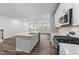 Open kitchen featuring white cabinets, quartz countertops, stainless appliances, and an island with seating at 156 Velvet Ridge Way, Garner, NC 27529