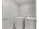 The laundry room features a washer, dryer and wire shelving at 156 Velvet Ridge Way, Garner, NC 27529
