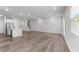 Spacious open-concept living room with hardwood floors and recessed lighting with kitchen in view at 156 Velvet Ridge Way, Garner, NC 27529