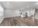 Open-concept living room with hardwood floors, recessed lighting, and access to the kitchen and staircase at 156 Velvet Ridge Way, Garner, NC 27529