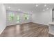 Living room featuring hardwood floors, recessed lighting, and access to the backyard through a glass door at 156 Velvet Ridge Way, Garner, NC 27529