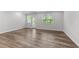 Living room with hardwood style floors, recessed lighting, neutral paint, and large window and door at 156 Velvet Ridge Way, Garner, NC 27529
