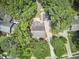 Aerial view of a home with backyard firepit area surrounded by lush greenery at 18 Clearwater Dr, Durham, NC 27707