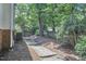 Stepping stone pathway leads to the private backyard, surrounded by trees at 18 Clearwater Dr, Durham, NC 27707