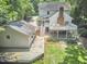 A deck and patio area grace the landscaped backyard of this two-story home with separate garage at 18 Clearwater Dr, Durham, NC 27707