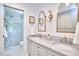 Bright bathroom featuring marble countertops and a glass-enclosed, marble tiled shower at 18 Clearwater Dr, Durham, NC 27707